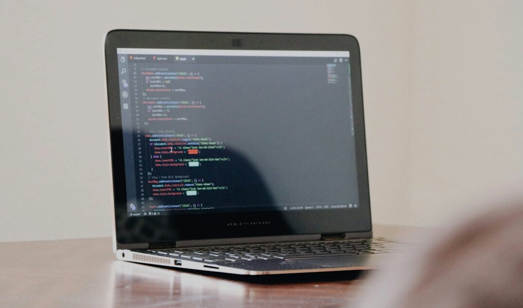student coding on laptop