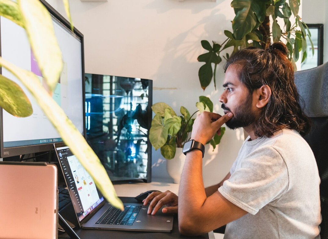 person coding on laptop at home