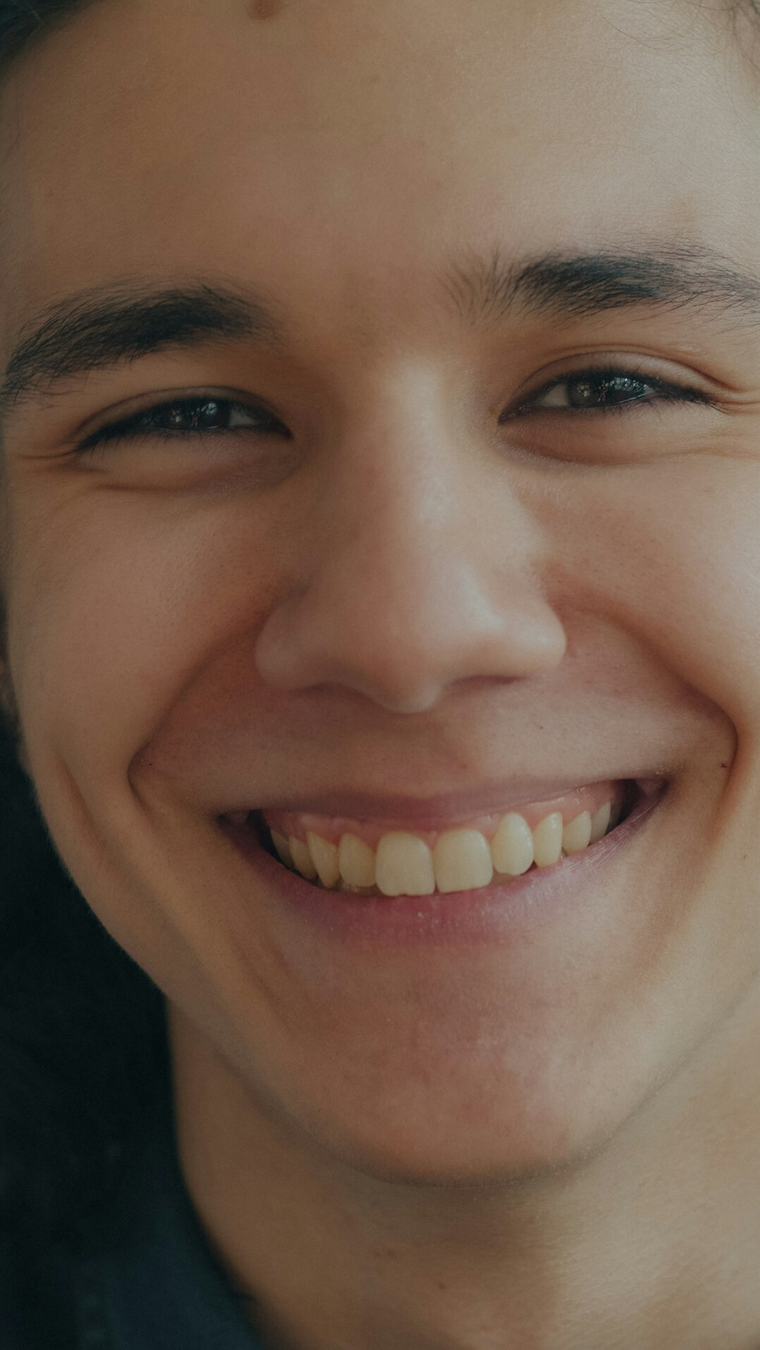 Portrait of a smiling man with short dark hair